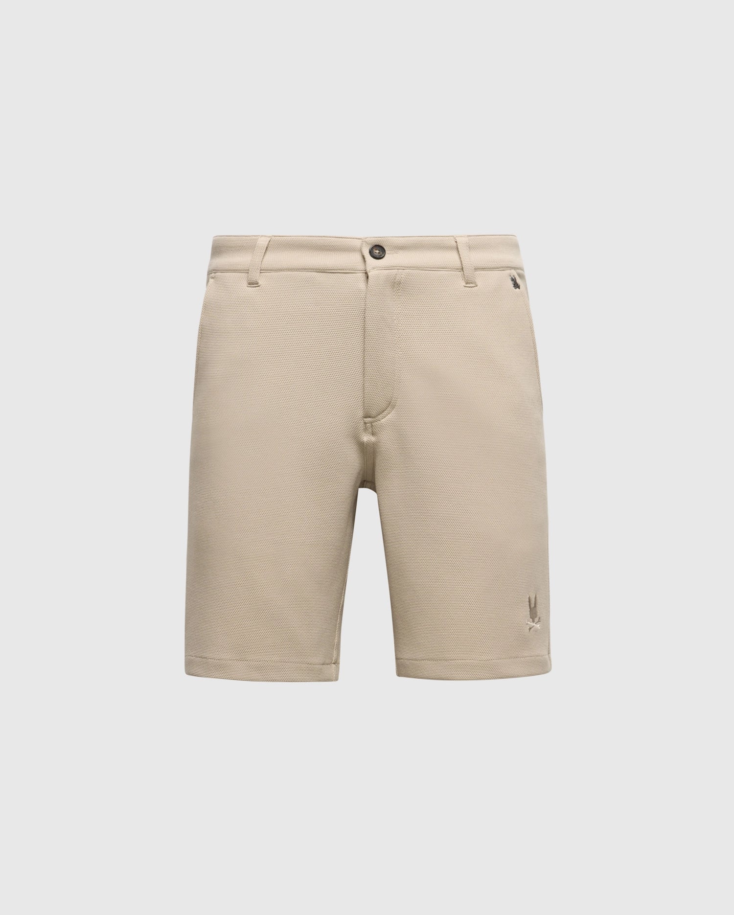 The Psycho Bunny MENS SHIRO KNIT HONEYCOMB SHORT (B6R585F200) is a beige, honeycomb-patterned piqué short with belt loops, front button and zipper closure, and a small embroidered logo near the left hem, shown on a white background.
