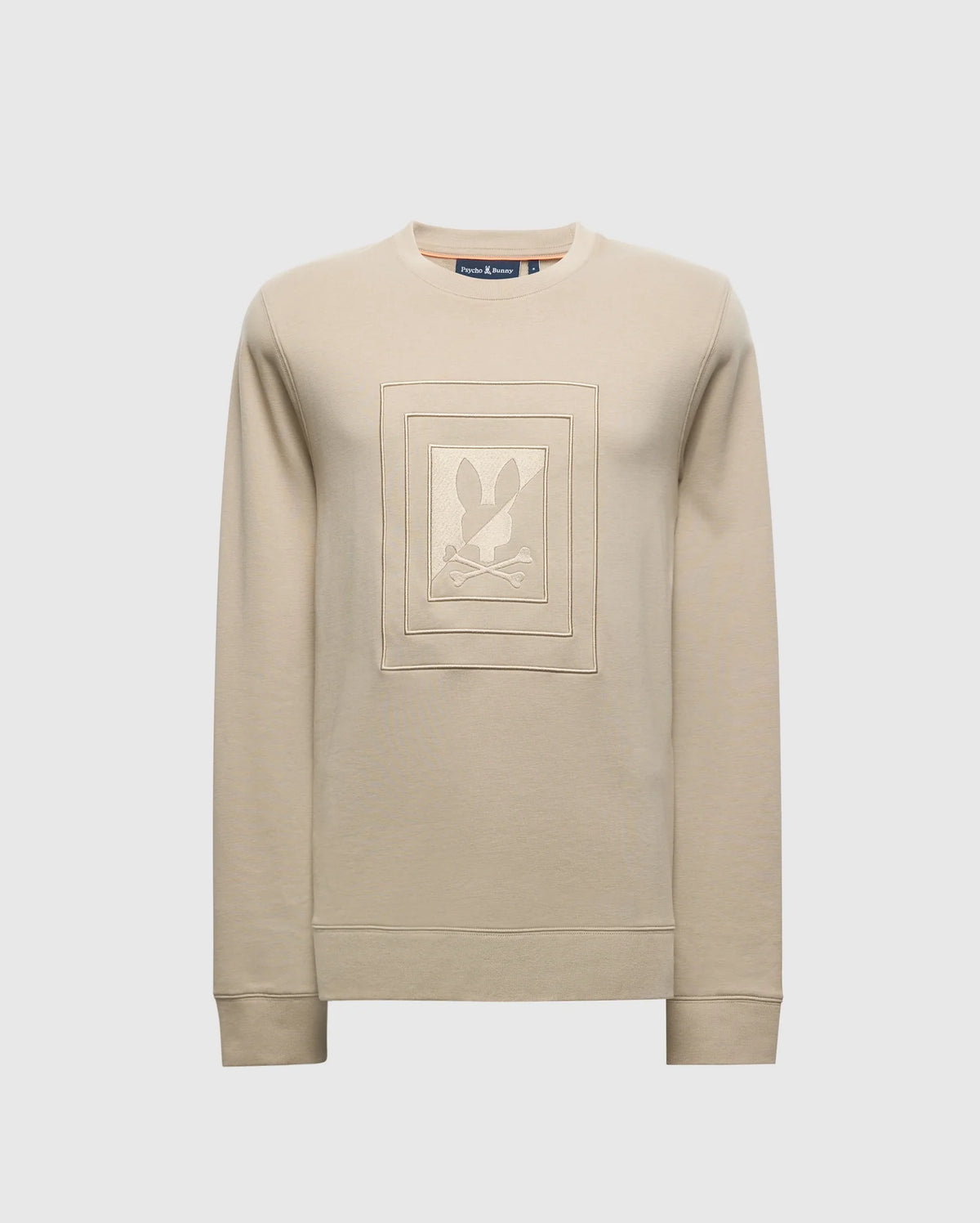 The MENS OAK CITY CREW NECK - B6S274E200 by Psycho Bunny is a beige, lightweight sweatshirt with a crew neckline and ribbed cuffs. It features a raised embroidery square design on the front with an abstract graphic at the center.