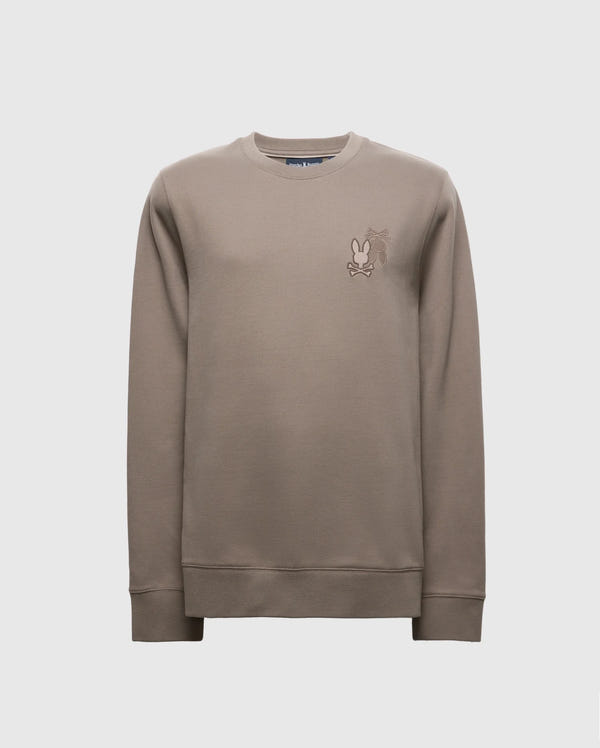 The Psycho Bunny MENS PIERCE PEACHED TERRY CREW - B6S278E200 is a stylish beige sweater made from premium cotton. It features an embroidered cartoon character on the chest and includes a classic crew neck with ribbed cuffs and hem, all set against a plain white background.
