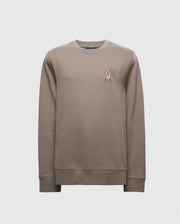 The Psycho Bunny MENS PIERCE PEACHED TERRY CREW - B6S278E200 is a stylish beige sweater made from premium cotton. It features an embroidered cartoon character on the chest and includes a classic crew neck with ribbed cuffs and hem, all set against a plain white background.