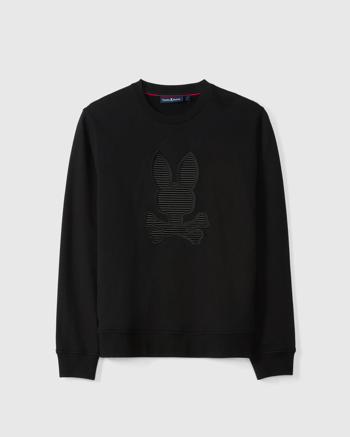 The MENS KINGSTON SWEATSHIRT - B6S480D200 by Psycho Bunny is a black cotton jersey sweatshirt. It features a subtle 3D-embroidery design of a bunny head and crossed bones on the front, with a crew neck and long sleeves, displayed against a plain white background.