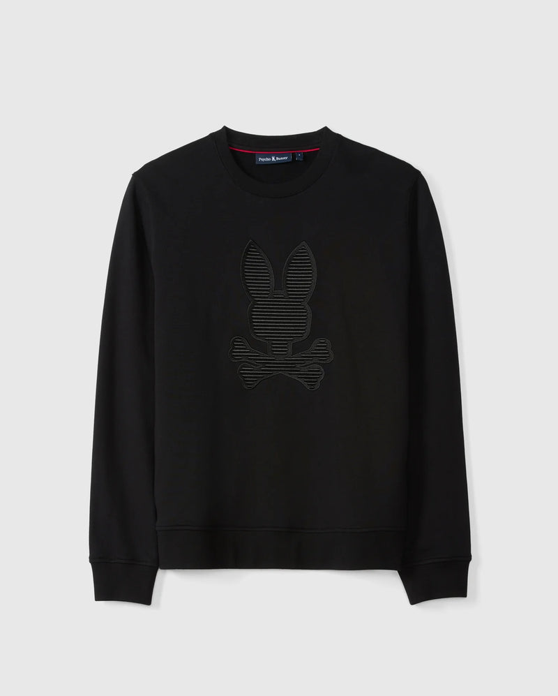 The MENS KINGSTON SWEATSHIRT - B6S480D200 by Psycho Bunny is a black cotton jersey sweatshirt. It features a subtle 3D-embroidery design of a bunny head and crossed bones on the front, with a crew neck and long sleeves, displayed against a plain white background.