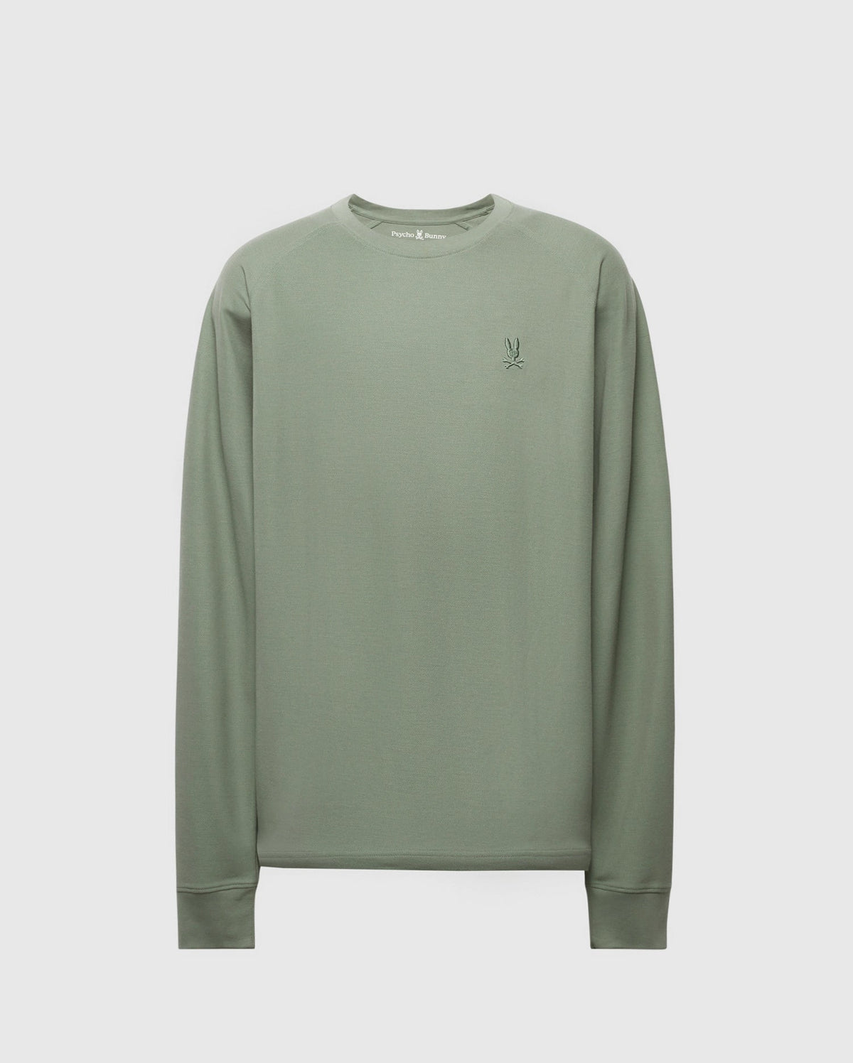 The MENS TAYLOR PIQUE LONG SLEEVE TEE by Psycho Bunny, in sage green, is crafted from soft Pima cotton and features an embroidered Bunny logo on the left chest. A light gray background highlights its elegant details.