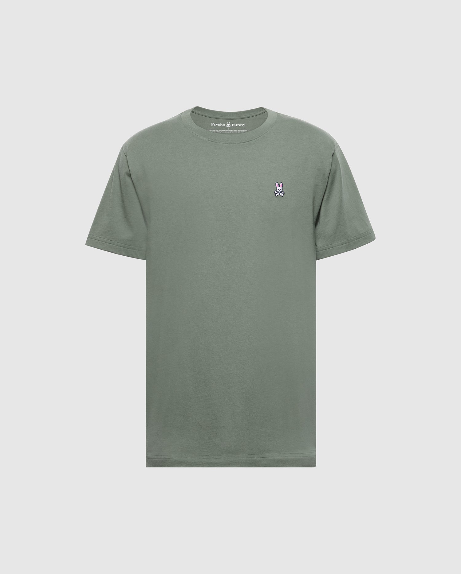 The Psycho Bunny Men's Classic Crew Neck Tee (B6U014B200) is a soft Pima cotton t-shirt in plain green, featuring a small embroidered bunny logo on the left chest. It's showcased against a light gray background, emphasizing its subtle charm.