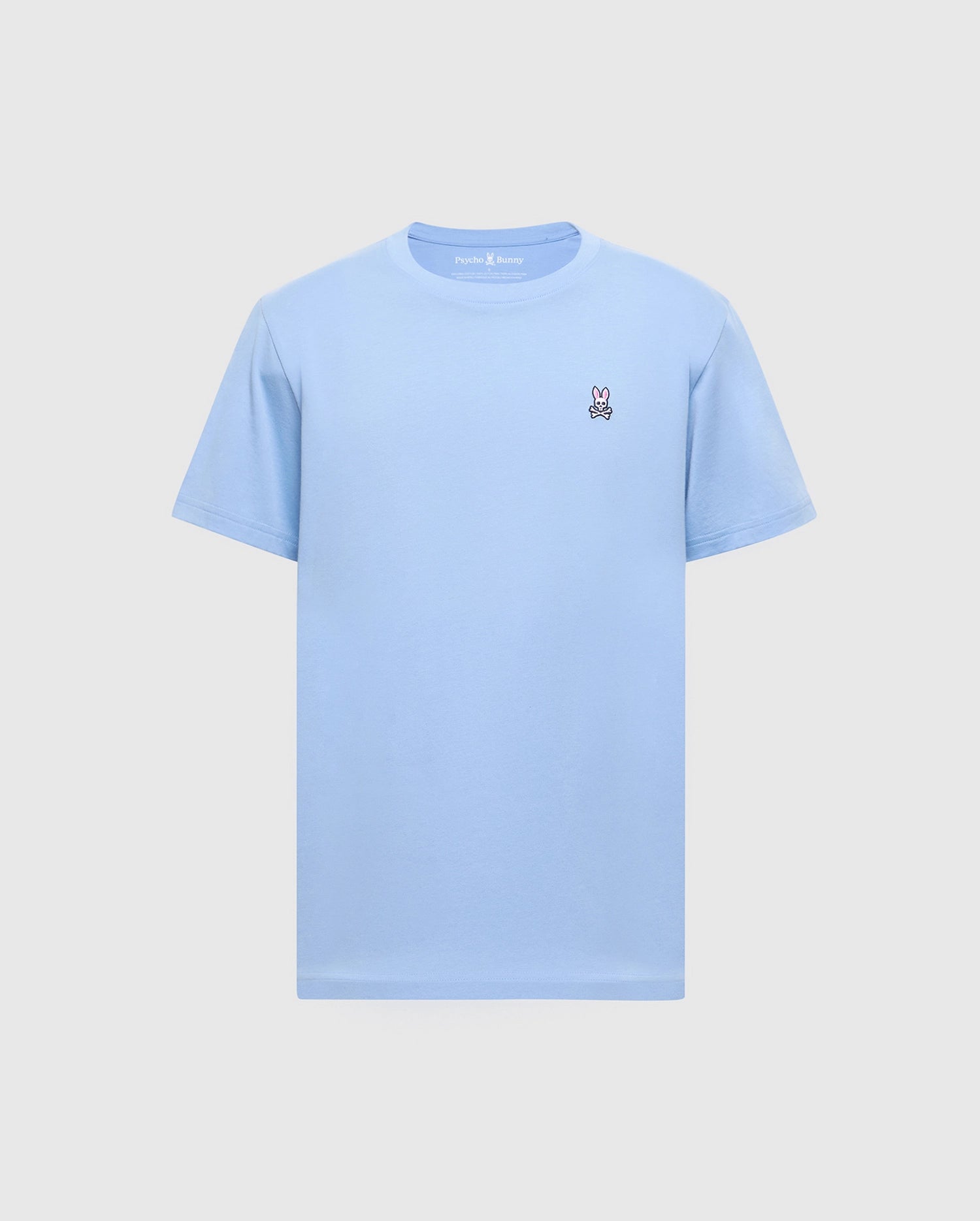 The Psycho Bunny Men's Classic Crew Neck Tee (B6U014B200) in light blue, made from soft Pima cotton, features an embroidered white peace sign hand on the left chest. Set against a grey background, it offers a seamless mix of comfort and style.