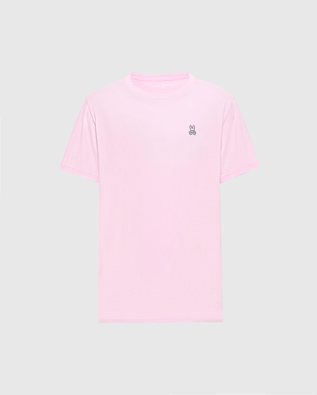 The Psycho Bunny MENS CLASSIC CREW NECK TEE - B6U014CRPC features a light pink color with short sleeves and a small embroidered peace sign on the upper left. Made from soft Pima cotton in a regular fit, it's shown on a plain gray background.