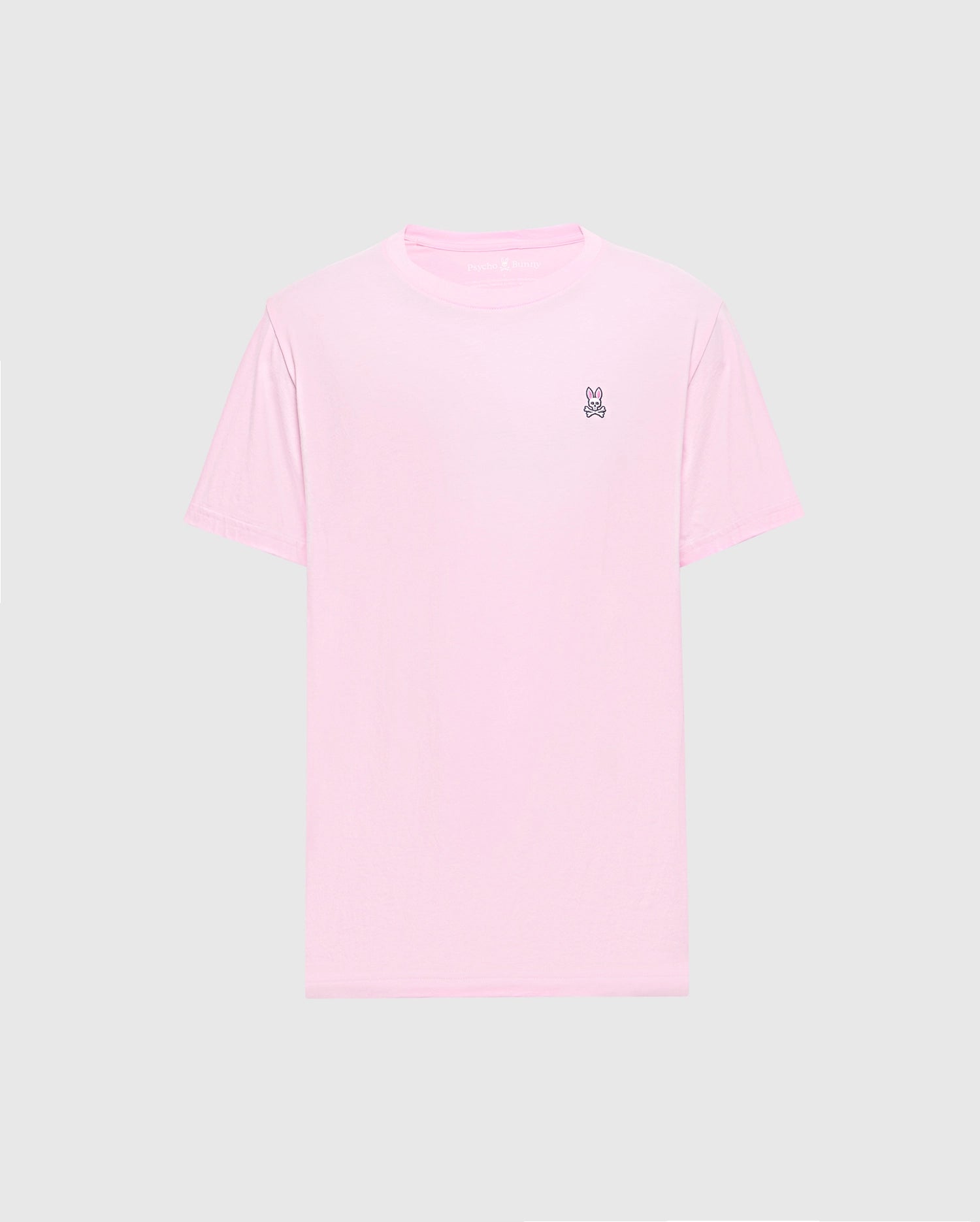 The Psycho Bunny MENS CLASSIC CREW NECK TEE - B6U014CRPC features a light pink color with short sleeves and a small embroidered peace sign on the upper left. Made from soft Pima cotton in a regular fit, it's shown on a plain gray background.