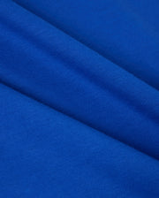 Close-up of vibrant blue Pima cotton with a smooth texture and diagonal folds. The material radiates a soft and lively appearance, highlighting the weave pattern—ideal for the Psycho Bunny Men's Classic Crew Neck Tee (B6U014CRPC) featuring an embroidered Bunny logo.