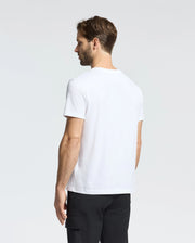 A short-haired man is seen from behind wearing a Psycho Bunny MENS CLASSIC CREW NECK TEE - B6U014CRPC, made from 100% Pima cotton, along with black pants, against a plain background.