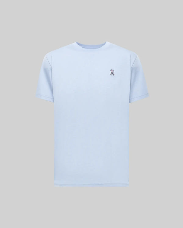 The Psycho Bunny MENS CLASSIC CREW NECK TEE (B6U014F200) in light blue features a small embroidered peace hand sign on the left chest and is made from soft Pima cotton, combining premium comfort and style. Displayed on a plain gray background.