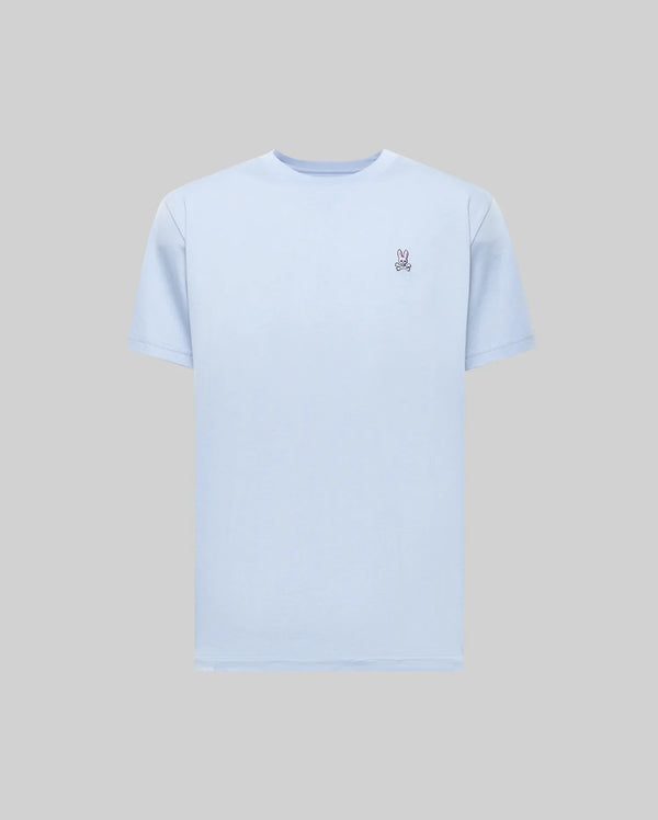 The Psycho Bunny MENS CLASSIC CREW NECK TEE (B6U014F200) in light blue features a small embroidered peace hand sign on the left chest and is made from soft Pima cotton, combining premium comfort and style. Displayed on a plain gray background.
