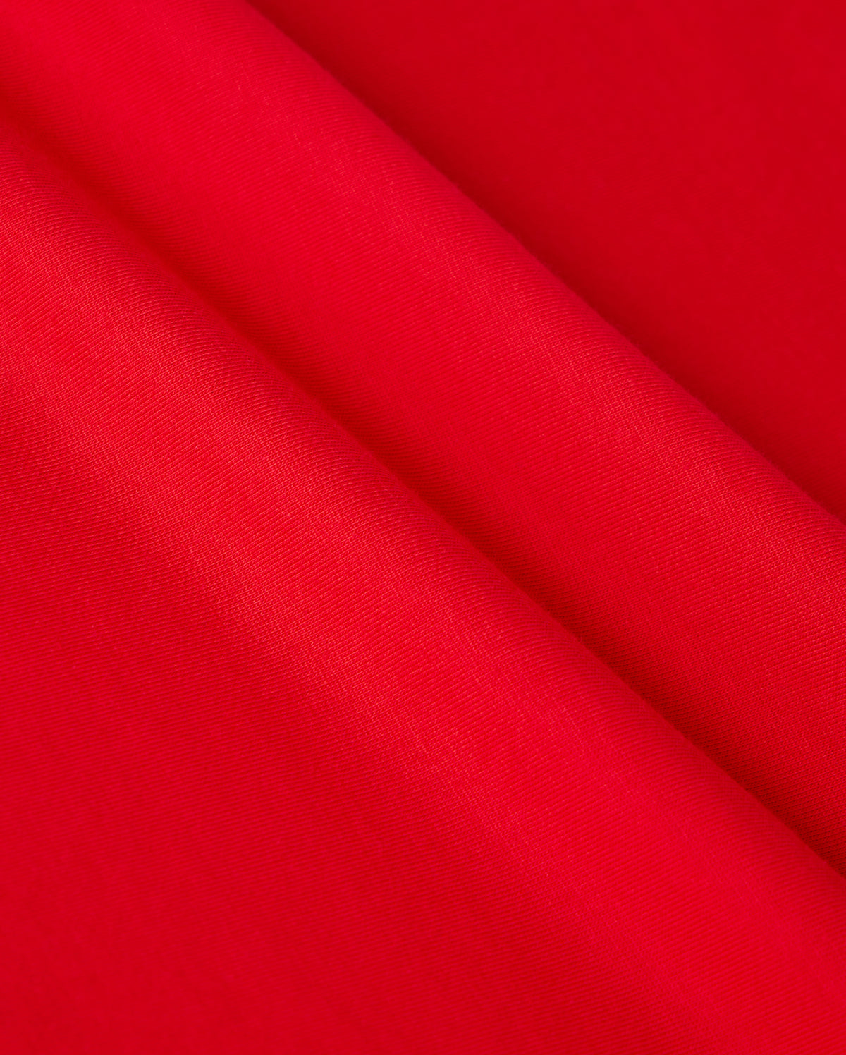 Close-up of vibrant red Pima cotton fabric draped in soft folds, showcasing the smooth texture and rich color reminiscent of the MENS CLASSIC V NECK TEE - B6U100CRPC by Psycho Bunny, adorned with the subtle elegance of its logo.