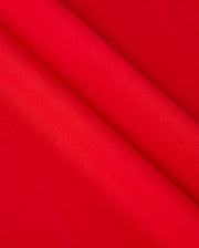 Close-up of vibrant red Pima cotton fabric draped in soft folds, showcasing the smooth texture and rich color reminiscent of the MENS CLASSIC V NECK TEE - B6U100CRPC by Psycho Bunny, adorned with the subtle elegance of its logo.