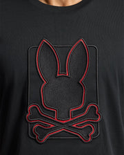 The Psycho Bunny MENS PIERCE EMBROIDERED GRAPHIC TEE - B6U115E200 is made from soft Pima cotton and features an eye-catching embroidered design of a black silhouette with bunny ears atop crossed bones. The bold red outline provides striking contrast, bringing the bunny embroidery to life against the sleek black fabric.