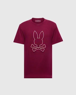 The MENS ALEXANDER GRAPHIC TEE (B6U163E200) by Psycho Bunny features a bold bunny skull and crossbones design on the front of a maroon Pima cotton shirt, set against a plain white background.