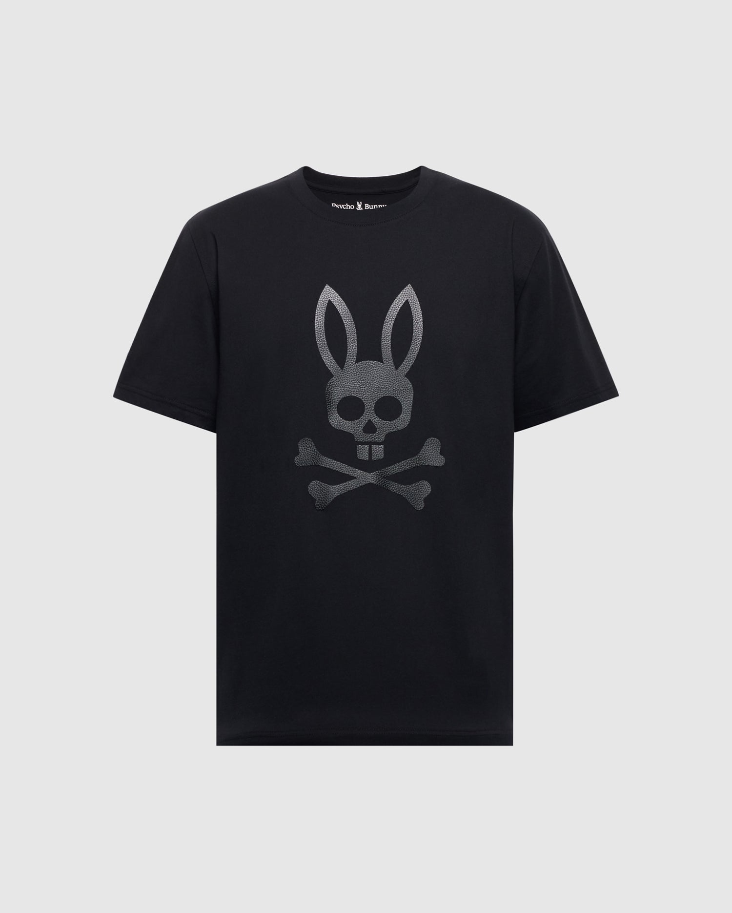 The Psycho Bunny Men's Payson Leather Print Graphic Tee (B6U213E200) is a black Pima cotton jersey tee with short sleeves and a round neckline, featuring a gray leather print of a bunny skull and crossbones on the front.