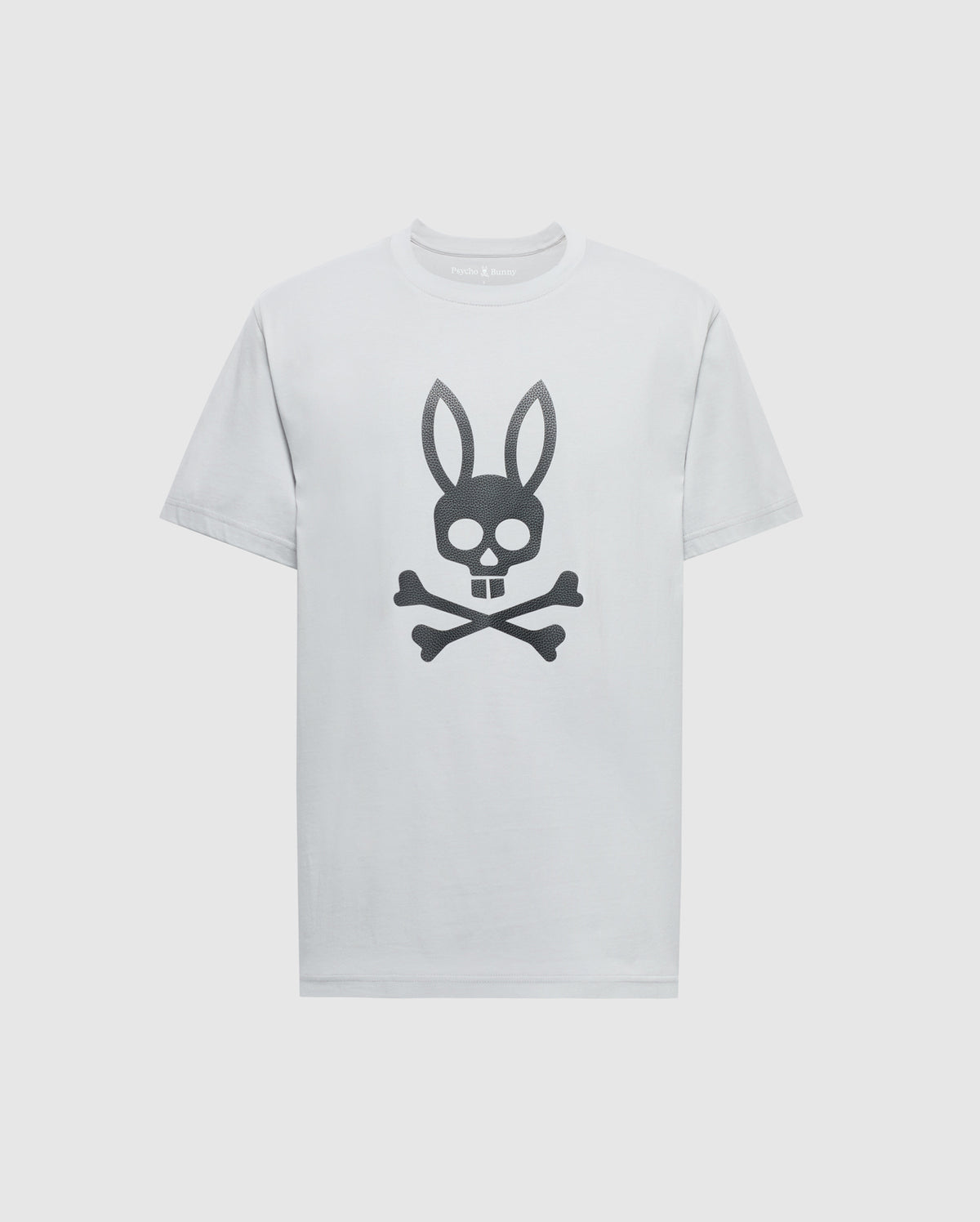 The Psycho Bunny MENS PAYSON LEATHER PRINT GRAPHIC TEE - B6U213E200 is a white Pima cotton jersey tee featuring a black leather skull with bunny ears above crossbones centered on the front.