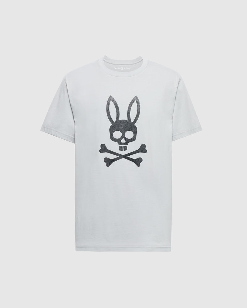 The Psycho Bunny MENS PAYSON LEATHER PRINT GRAPHIC TEE - B6U213E200 is a white Pima cotton jersey tee featuring a black leather skull with bunny ears above crossbones centered on the front.