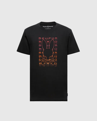 The Men's Cortes Graphic Tee by Psycho Bunny features a bold, stylish rabbit's head and crossbones silhouette with a vertical "Psycho" text, enhanced by an orange and red gradient effect.