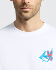 A man’s lower face and upper torso are visible as he wears the Psycho Bunny MENS MONTREAL TEE (B6U381F200), a white Pima cotton shirt with a small blue and pink chest graphic showing the number 4, bunny face, and “Mil.”.