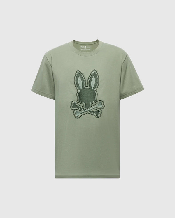The MENS NEW CASTLE EMBROIDERED GRAPHIC TEE - B6U415F200 by Psycho Bunny is crafted from Pima cotton and features a bunny graphic with crossed bones on the front, highlighted by two-tone embroidery.