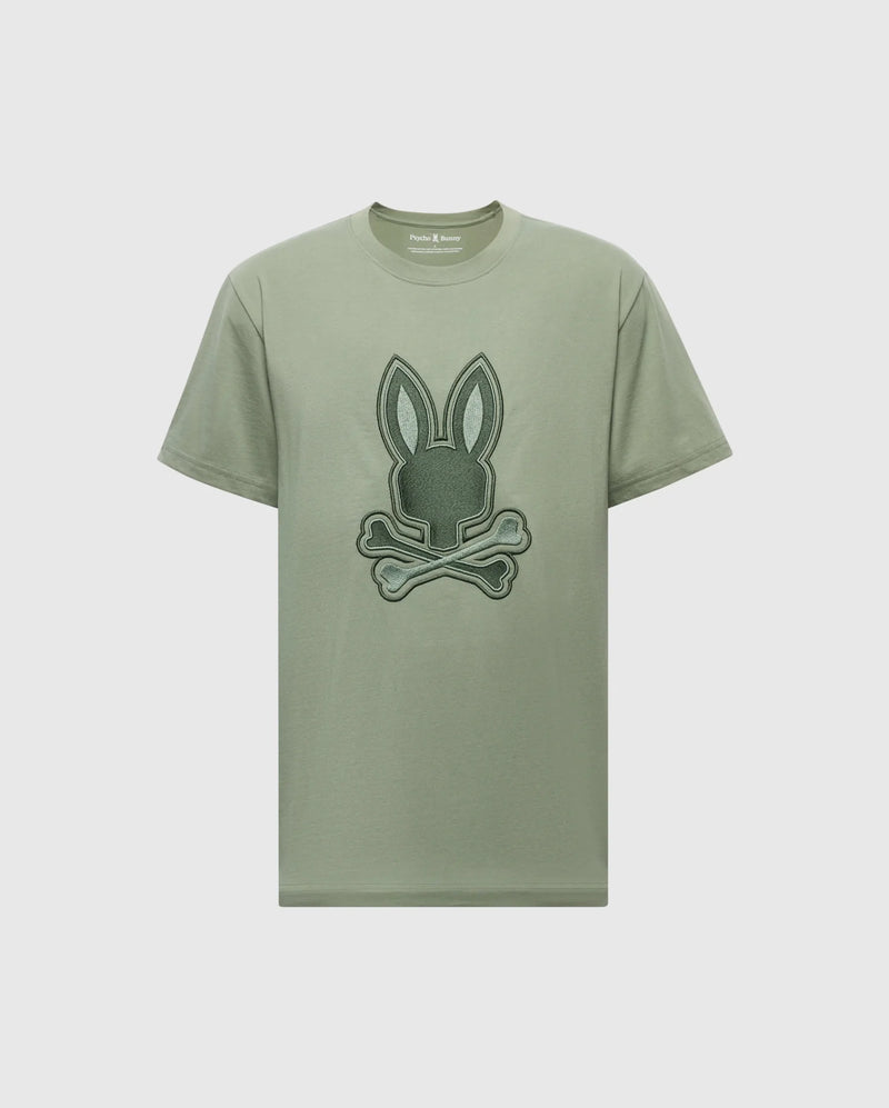 The MENS NEW CASTLE EMBROIDERED GRAPHIC TEE - B6U415F200 by Psycho Bunny is crafted from Pima cotton and features a bunny graphic with crossed bones on the front, highlighted by two-tone embroidery.