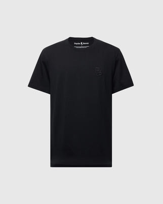 The Men's Nicholson PB Chest Graphic Tee by Psycho Bunny is a black T-shirt made from soft Pima cotton. It features a small embroidered logo on the left chest and an inside collar label with white text, offering a regular fit silhouette against a light gray backdrop.