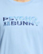 Close-up of the breathable light blue Psycho Bunny Men's Berni Embroidered Wordmark Graphic Tee featuring the embroidered text "PSYCHO BUNNY" in blue and two stylized bunny logos between the words.