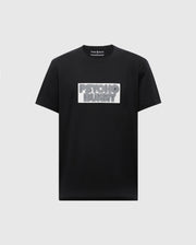 The Psycho Bunny MENS SYDNEY WORDMARK GRAPHIC TEE (B6U510F200) is a black Pima cotton short-sleeve shirt with a bold, outlined "PSYCHO BUNNY" white patch graphic on the chest, printed in premium water-based ink.