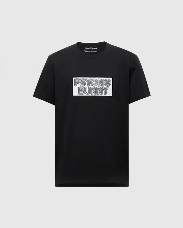 The Psycho Bunny MENS SYDNEY WORDMARK GRAPHIC TEE (B6U510F200) is a black Pima cotton short-sleeve shirt with a bold, outlined "PSYCHO BUNNY" white patch graphic on the chest, printed in premium water-based ink.