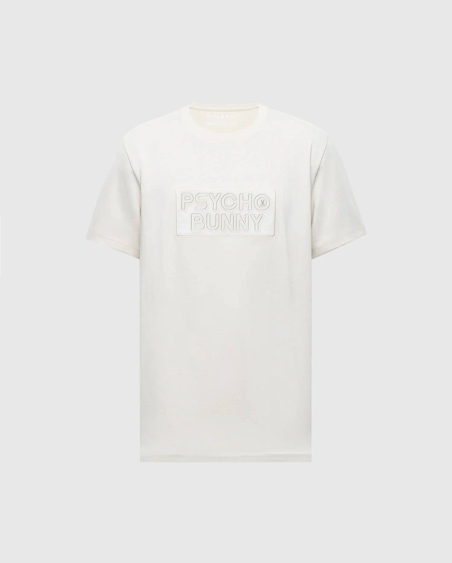 The Psycho Bunny MENS SYDNEY WORDMARK GRAPHIC TEE (B6U510F200) is a white short-sleeve Pima cotton shirt with a chest patch featuring the embossed Sydney Wordmark graphic on a light gray background.