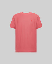 The Psycho Bunny MENS TAYLOR PIQUE TEE - B6U579F200 is a coral pink, short-sleeve Pima cotton t-shirt with a small embroidered logo on the left chest, shown against a light gray background.