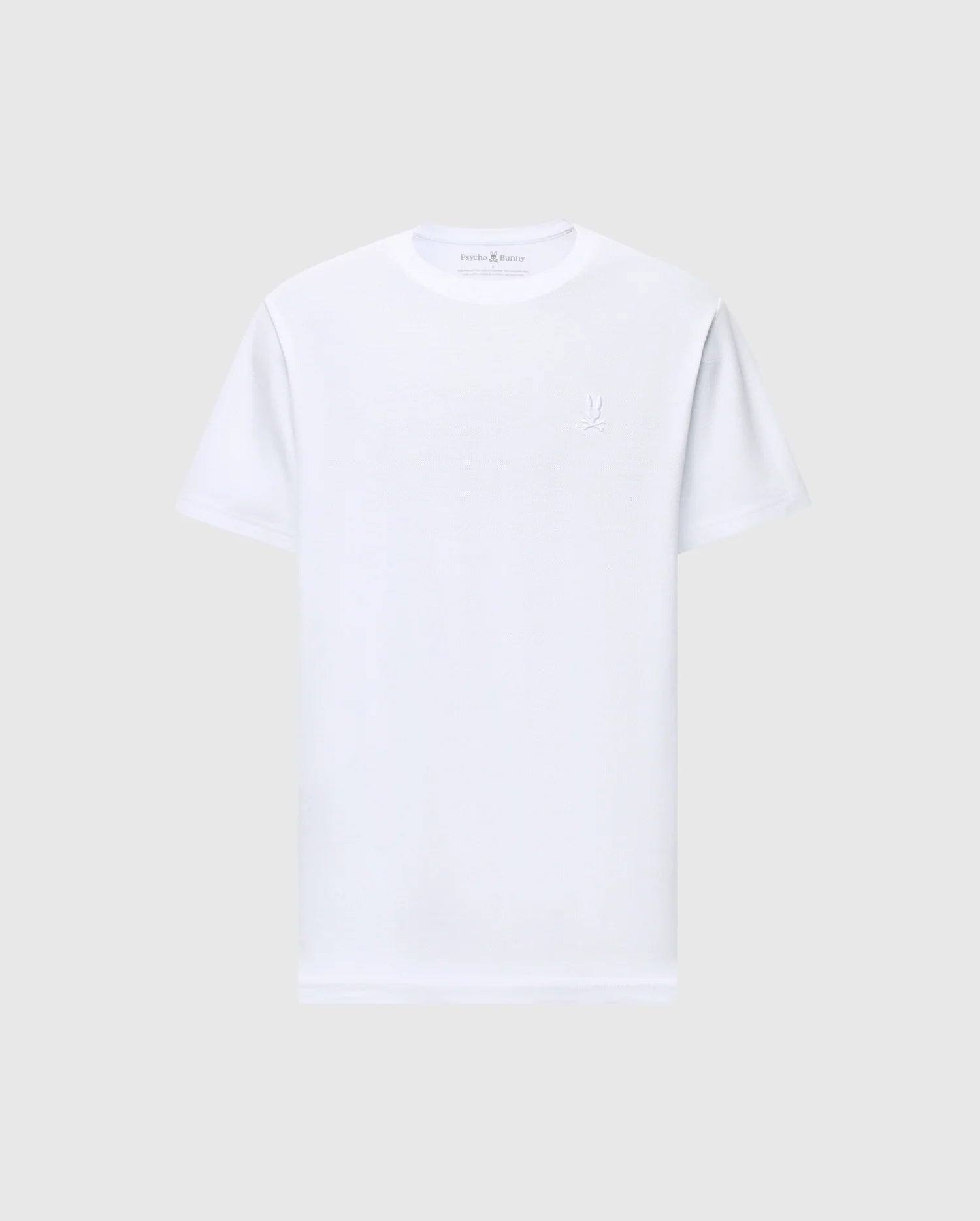 On a plain light gray background, the MENS TAYLOR PIQUE TEE by Psycho Bunny is a white short-sleeve crew neck t-shirt made from lightweight Pima cotton with a regular fit and features a subtle embroidered Bunny logo on the left chest.