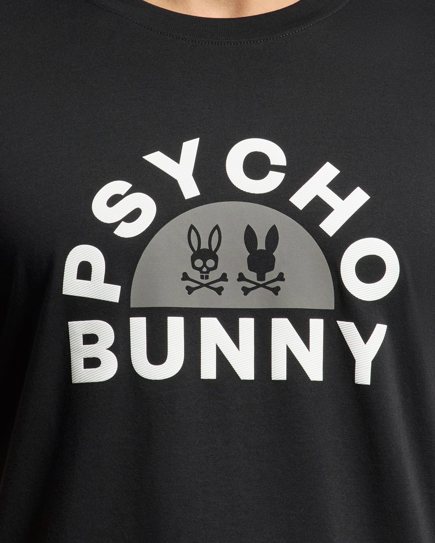 The Psycho Bunny MENS GOLDIE GRAPHIC TEE - B6U606F200 in black Pima cotton showcases "PSYCHO BUNNY" in bold white letters with two bunny skull logos resembling pirate symbols below—a striking bunny design.