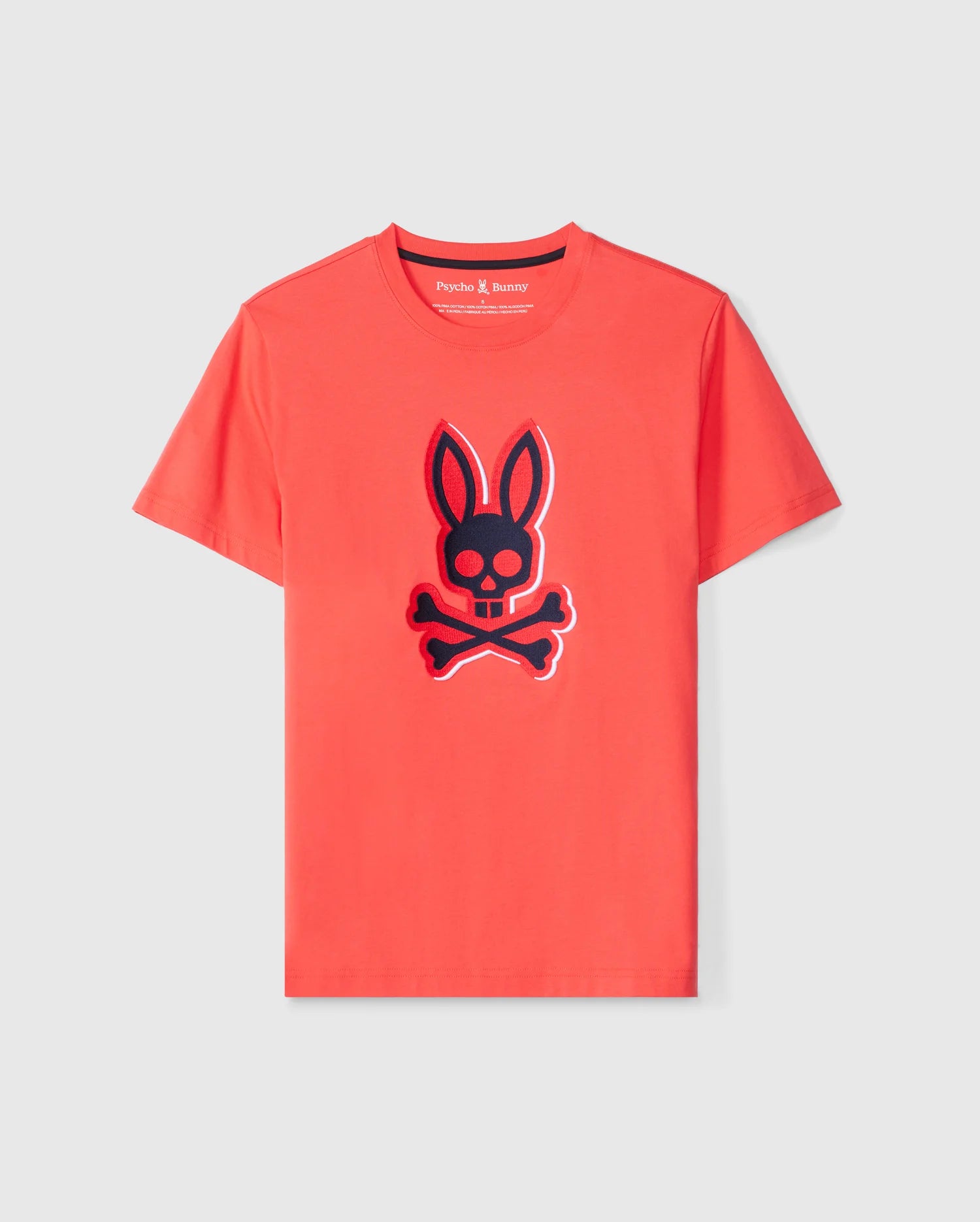 The MENS KAYDEN GRAPHIC TEE - B6U676C200 by Psycho Bunny is a vivid red short-sleeved graphic tee made from soft Pima cotton. It features a prominent black and red bunny head with crossbones graphic on the front and has a small neckline label that reads 
