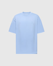 The Mens Duke Heavy Weight Relaxed Fit Tee by Psycho Bunny is a light blue, short-sleeve T-shirt made from luxurious Pima cotton. It features a subtle embroidered design on the top left and comes with a plain gray background.