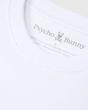 Close-up of a white Psycho Bunny MENS DUKE OVERSIZED TEE - B6U742D200 collar, displaying a printed label with the brand’s typography and logo, featuring a bunny with crossbones. Text indicates the shirt is made from 100% heavyweight Pima cotton and made in Peru.