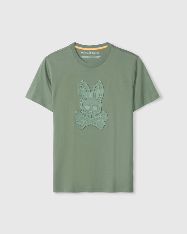 The Psycho Bunny MENS MALTON GRAPHIC TEE - B6U795D200 is a green short-sleeve graphic tee crafted from luxurious Pima cotton. It features an embroidered bunny skull and crossbones on the chest, along with a stylish orange accent on the inner neckline of the crew neck. Made in Peru, this tee offers exceptional quality and comfort.