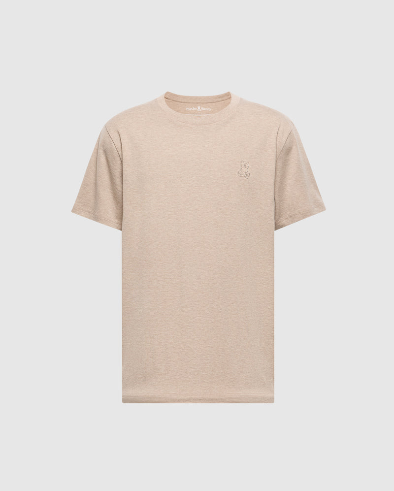 The Mens James Premium Crew Neck Tee by Psycho Bunny is a beige short-sleeve T-shirt made from quality Pima cotton, featuring a small embroidered rabbit outline on the left chest against a plain white background.