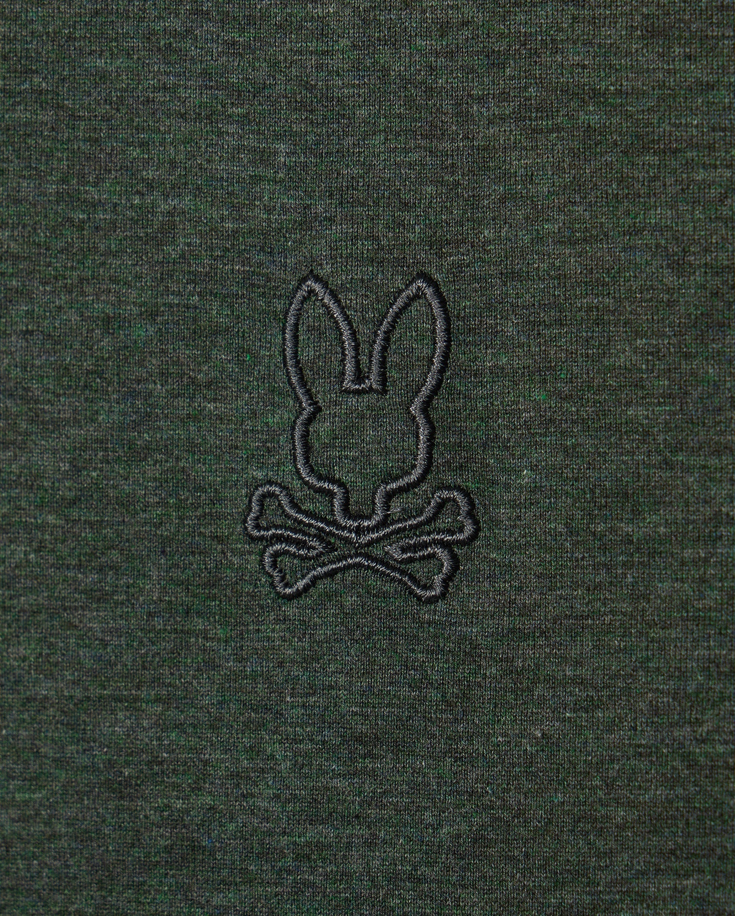 Introducing the Psycho Bunny MENS JAMES PREMIUM CREW NECK TEE - B6U952D200: This premium Pima cotton t-shirt in dark green features an embroidered design of a rabbit's head above crossed bones, reminiscent of a Jolly Roger symbol. The stylish crew neck boasts a design stitched in black thread.