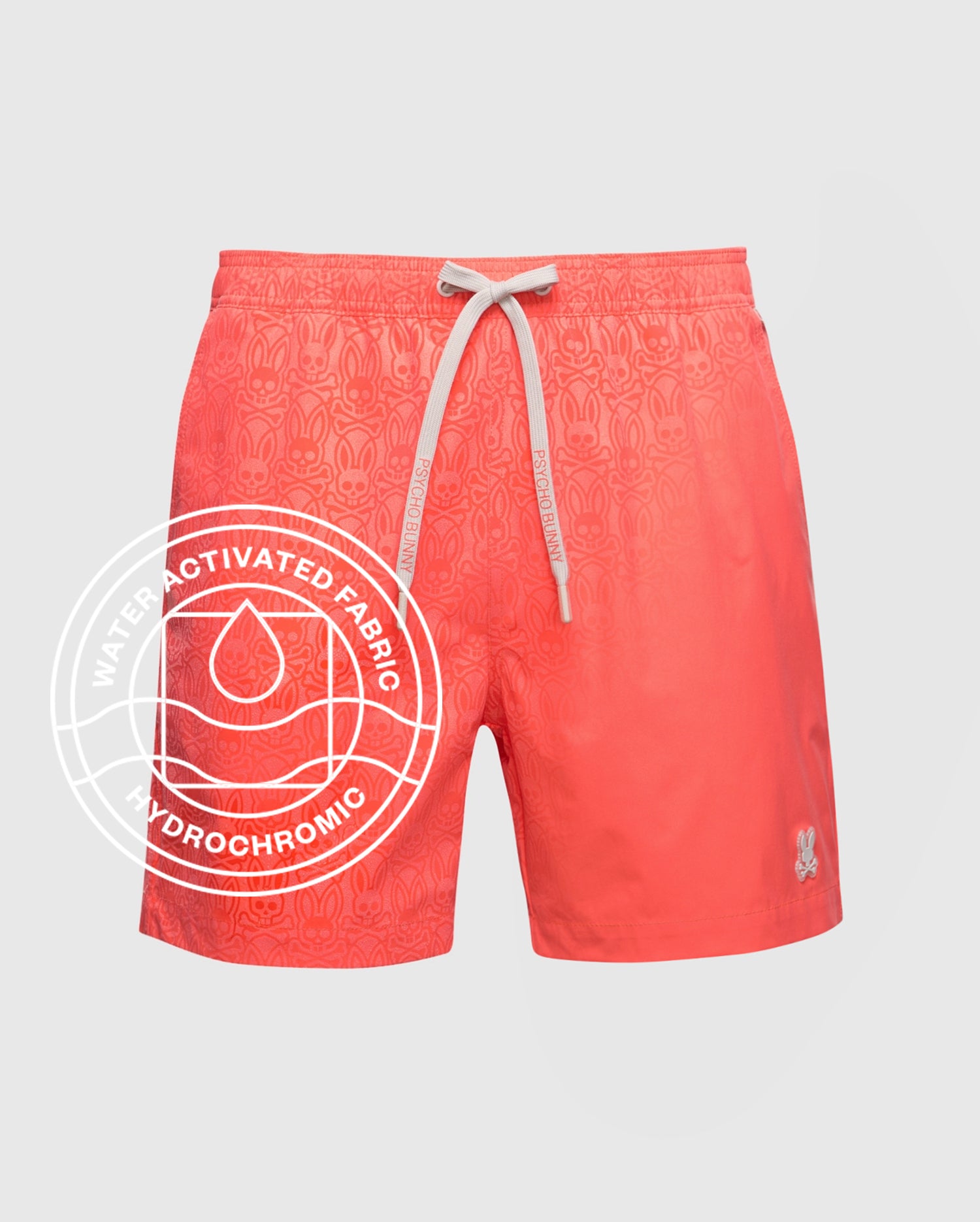 Psycho Bunny MENS SAMOS HYDROCHROMIC PRINTED SWIM TRUNK - B6W453F200 in coral features a white drawstring, subtle print, and small embroidered logo. Circular text reads "Water Activated Hydrochromic Fabric" with a water droplet icon. Perfect for pool parties!.