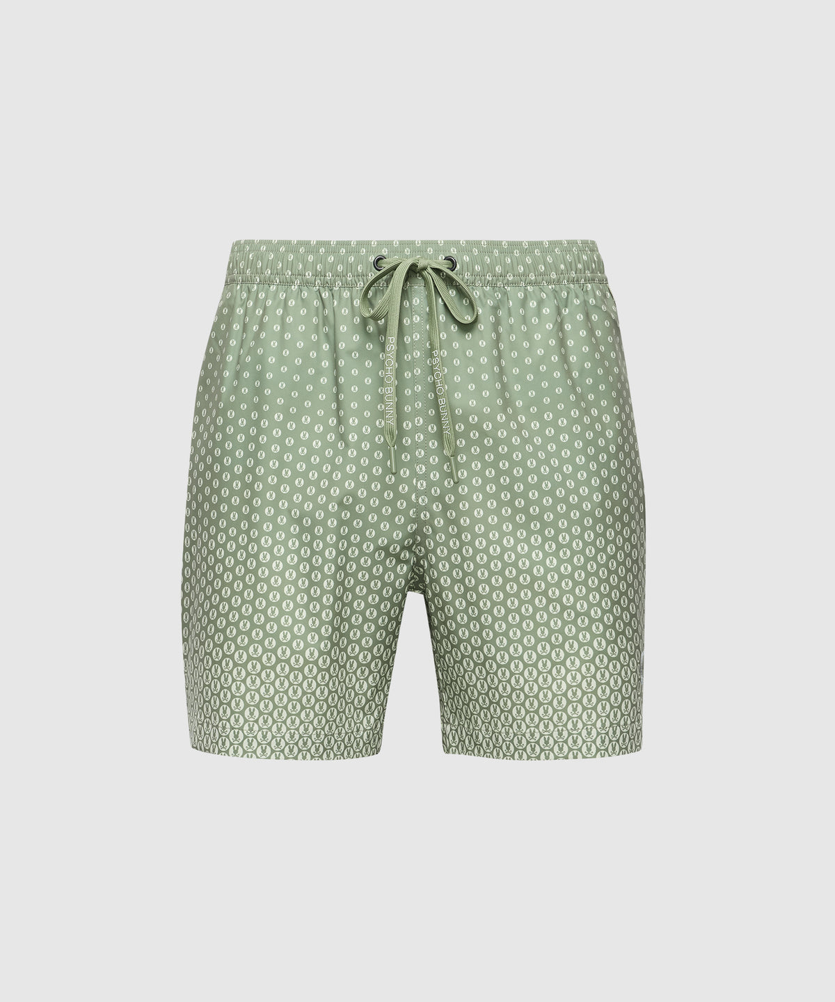 The Psycho Bunny MENS BENDIGO ALL OVER PRINTED SWIM TRUNK (B6W619F200) showcases green shorts with a white geometric bunny pattern, an elastic drawstring waistband, and quick-dry fabric. Displayed on a plain white background.