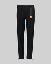 The Psycho Bunny KIDS MATHIEU COMMUTER PANT (KB0600002) features a black straight-leg, classic fit with waistband, button and front zipper. A black tag with keychain and orange label hangs from a belt loop. Shown on a light gray background.