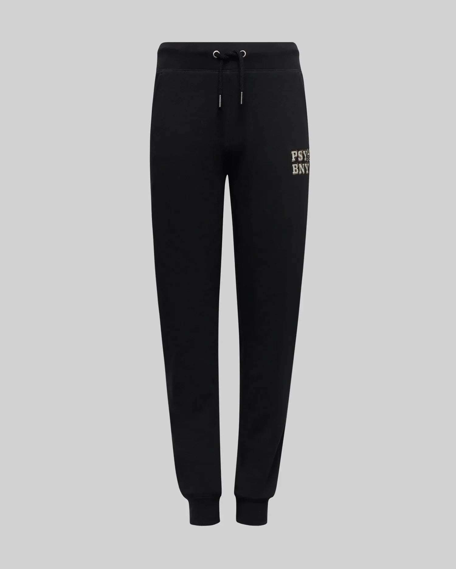 The Psycho Bunny KIDS WADE CORD PATCH SWEATPANT (KB0800002) features black premium cotton-blend sweatpants with an elastic waistband, drawstring, fitted cuffs, and a small printed logo on the left thigh. Shown on a light gray background.