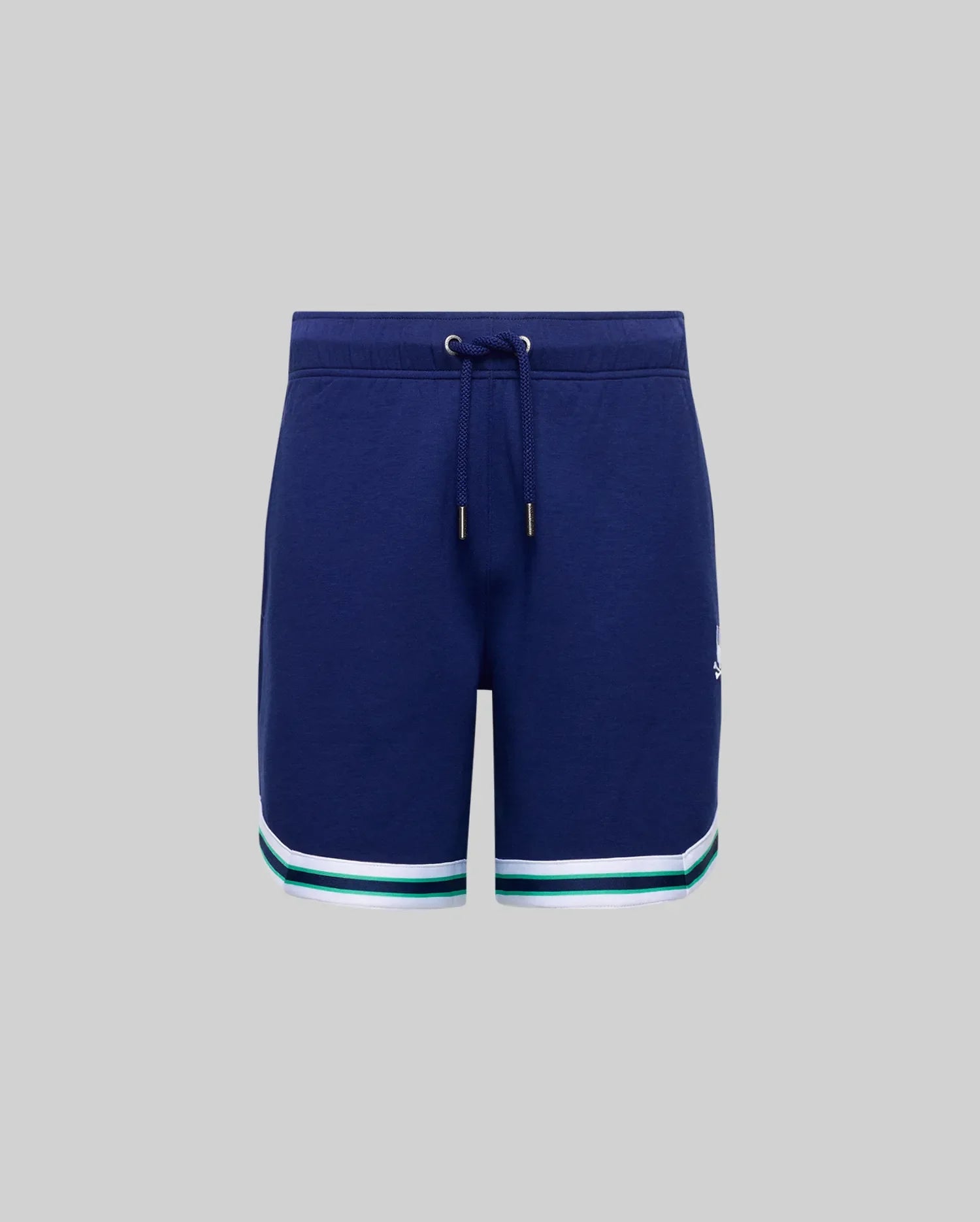 The KIDS BASIL TAPED SHORT (KB0900003) by Psycho Bunny features a navy blue cotton-modal blend with a drawstring waist and white and green striped hems, shown against a plain gray background.