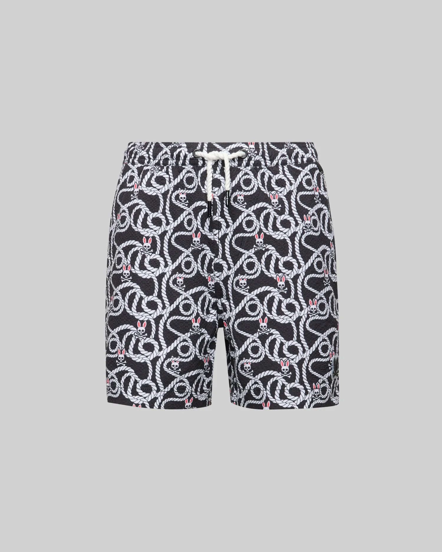 Psycho Bunny KIDS CYRUS ALL OVER PRINT SWIM TRUNK - KB1000001: Black quick-dry seersucker swim trunks with a white snake print and red accents, elastic waistband, and white drawstring, shown on a gray background for effortless coastal style.