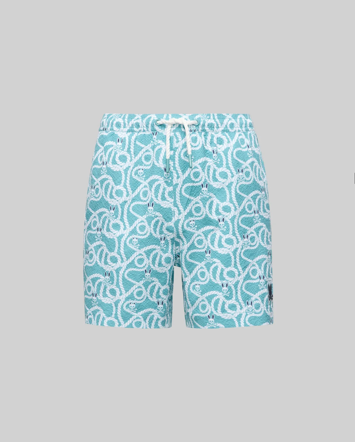 The Psycho Bunny KIDS CYRUS ALL OVER PRINT SWIM TRUNK - KB1000001 features a turquoise, quick-drying fabric with a white rope and knot pattern, elastic waistband, white drawstring, black patch by the hem, shown on a light grey background.