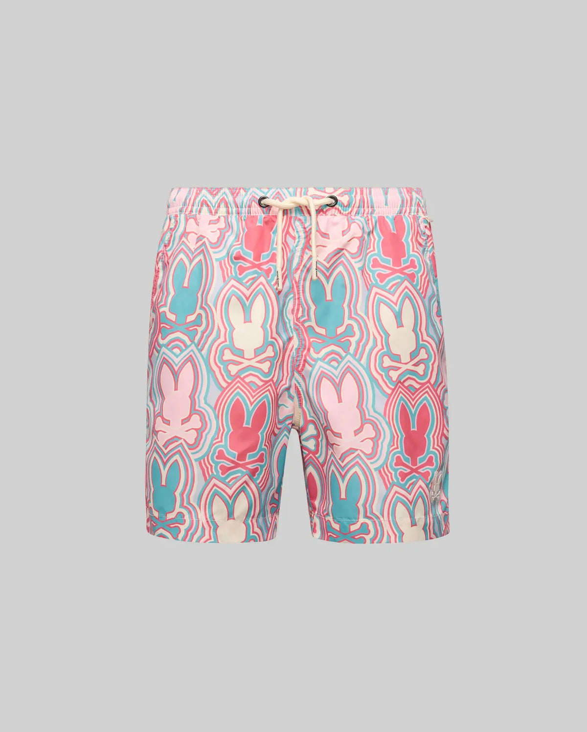 The Psycho Bunny KIDS CHUCK ALL OVER PRINT LIGHTWEIGHT SWIM TRUNK (KB1000002) features a colorful Bunny print in pink, blue, cream, and red on quick-dry recycled fabric with an elastic waistband and white drawstring, shown on a grey background.