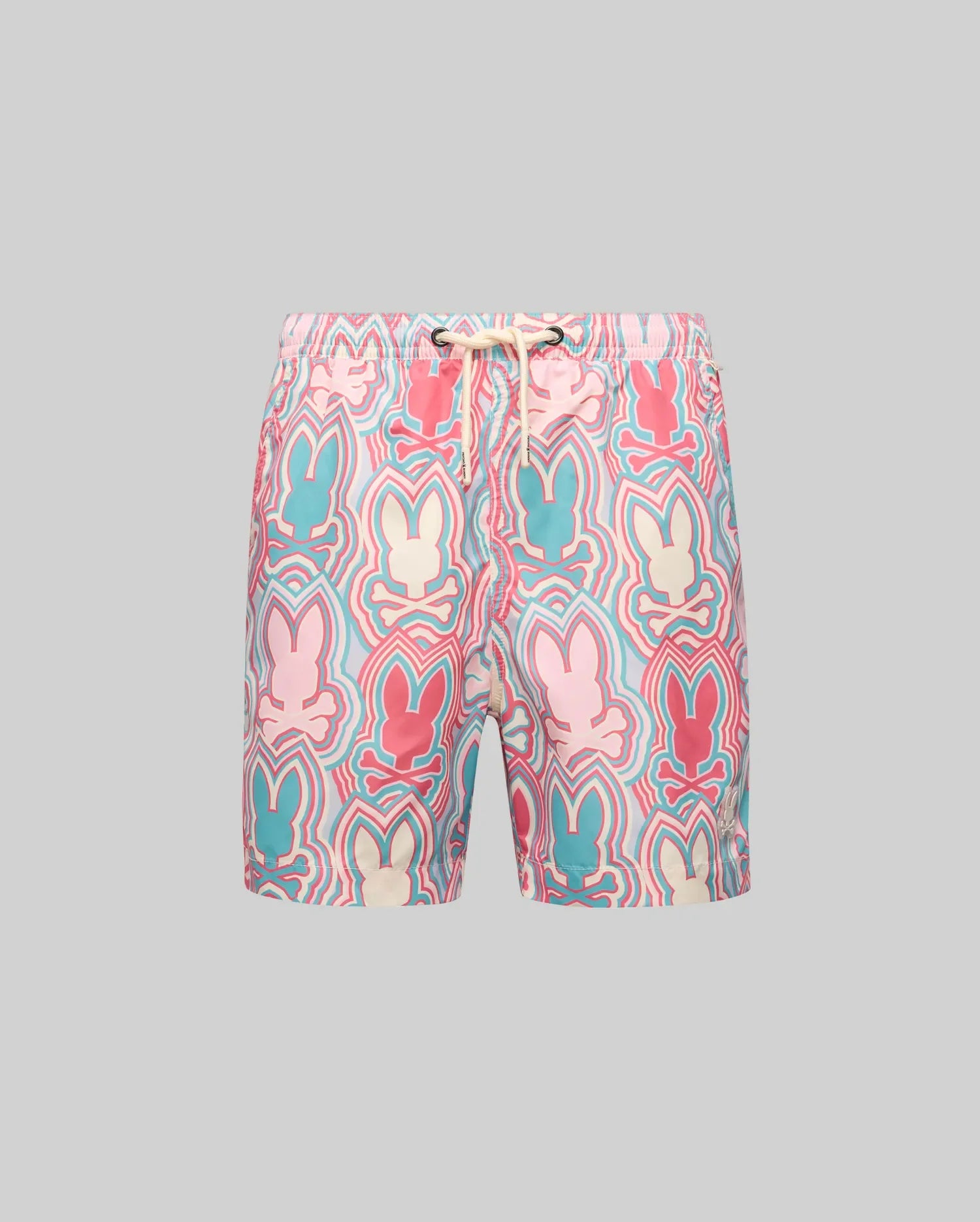 The Psycho Bunny KIDS CHUCK ALL OVER PRINT LIGHTWEIGHT SWIM TRUNK (KB1000002) features a colorful Bunny print in pink, blue, cream, and red on quick-dry recycled fabric with an elastic waistband and white drawstring, shown on a grey background.