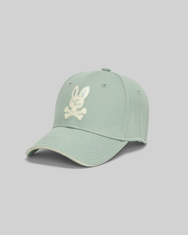 The KIDS DEREK BASEBALL CAP - KO1500008 by Psycho Bunny is a bold light green cotton cap with a white bunny skull-and-crossbones on the front, shown against a plain gray background.